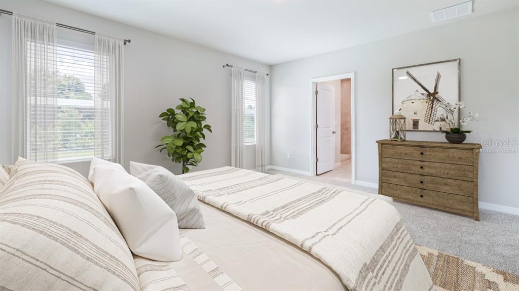9450 Turtle Grass Circle Punta Gorda, FL 33950 - Photo 11 of 35 a bedroom with a bed and dresser