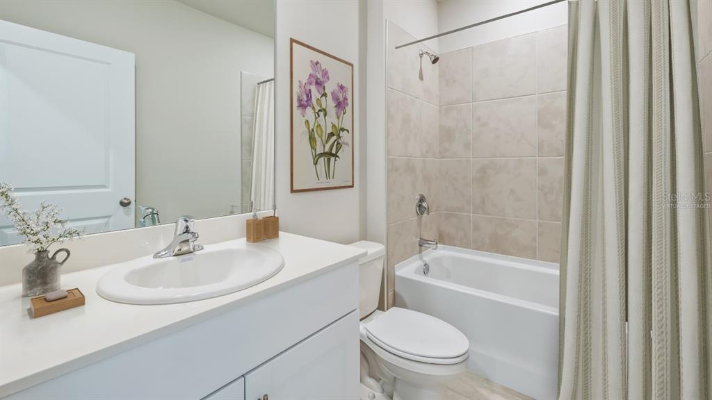 9450 Turtle Grass Circle Punta Gorda, FL 33950 - Photo 12 of 35 a bathroom with a sink a toilet and shower