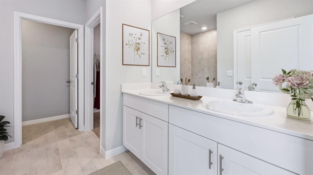9450 Turtle Grass Circle Punta Gorda, FL 33950 - Photo 14 of 35 a bathroom with double sink and a mirror