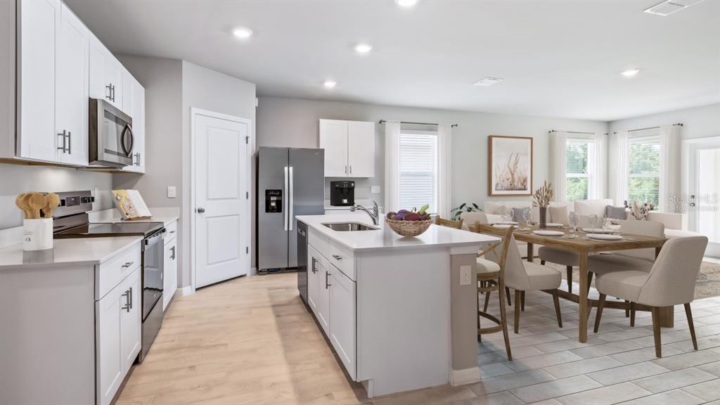 9450 Turtle Grass Circle Punta Gorda, FL 33950 - Photo 5 of 35 a kitchen with cabinets and chairs
