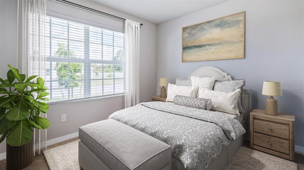 9450 Turtle Grass Circle Punta Gorda, FL 33950 - Photo 6 of 35 a bedroom with a bed and a potted plant