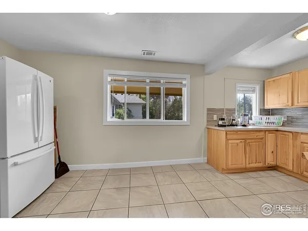 a kitchen with a refrigerator a sink and a window