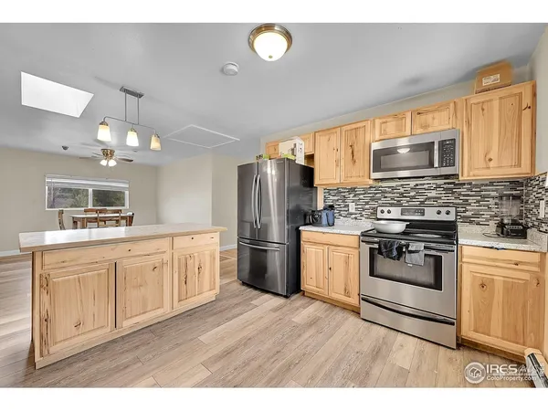 a kitchen with a refrigerator stove top oven and sink