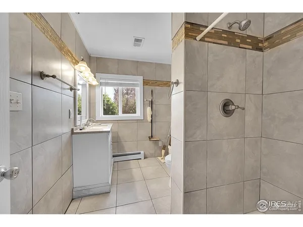 a bathroom with a shower and a sink