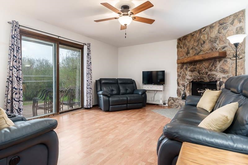 3824 Valerie Road Roscoe, IL 61073 - Photo 12 of 33 a living room with furniture a flat screen tv and a large window