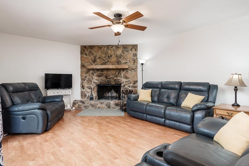 3824 Valerie Road Roscoe, IL 61073 - Photo 13 of 33 a living room with furniture a flat screen tv and a fireplace