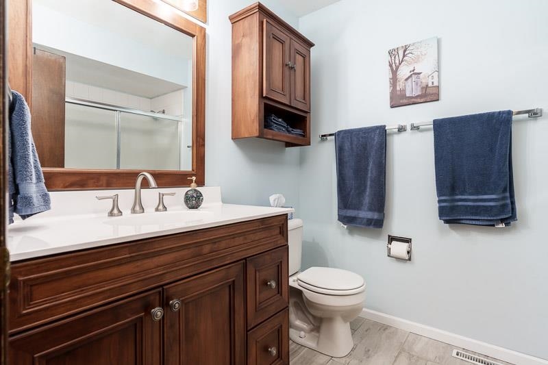 3824 Valerie Road Roscoe, IL 61073 - Photo 16 of 33 a bathroom with a toilet a sink and mirror