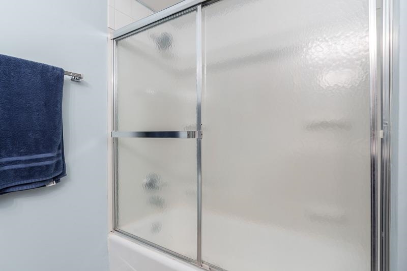 3824 Valerie Road Roscoe, IL 61073 - Photo 17 of 33 a bathroom with a glass shower door