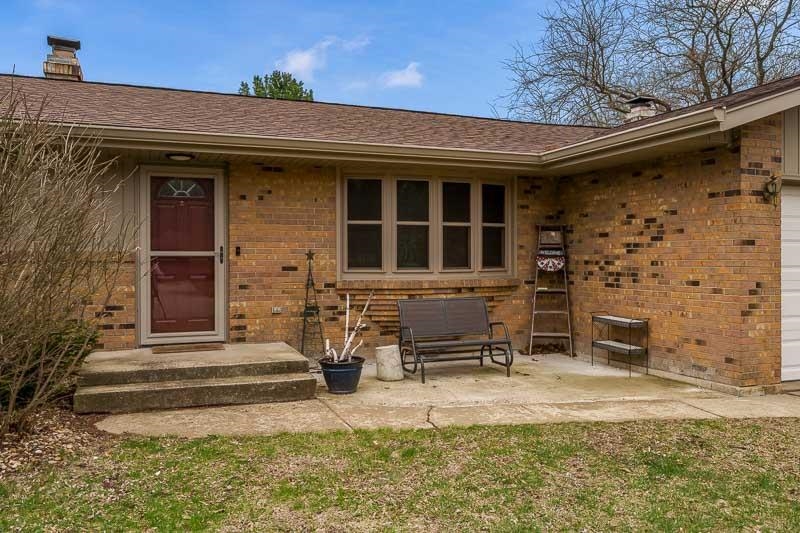 3824 Valerie Road Roscoe, IL 61073 - Photo 31 of 33 a front view of a house with outdoor seating and barbeque oven
