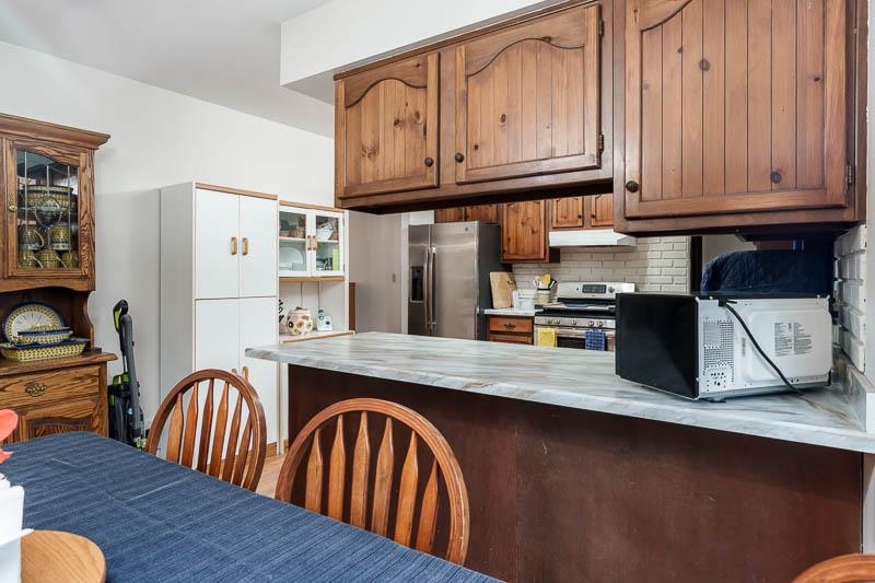 3824 Valerie Road Roscoe, IL 61073 - Photo 10 of 33 a kitchen with stainless steel appliances granite countertop a refrigerator a stove a sink dishwasher and cabinets with wooden floor