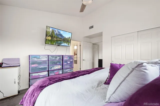 a bathroom with a granite countertop toilet sink and mirror