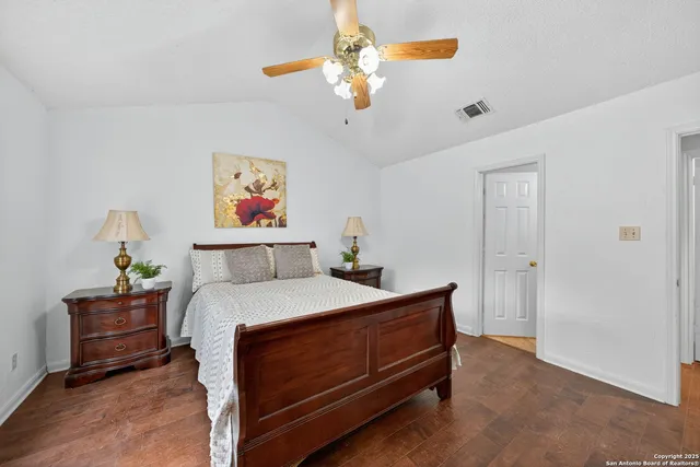a bedroom with a bed and a chandelier