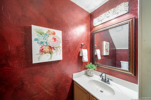 a bathroom with a sink mirror and vanity