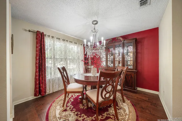 a view of a dining room with furniture and window