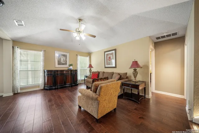 a living room with furniture and a wooden floor