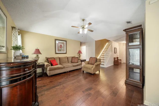 a living room with furniture and wooden floor