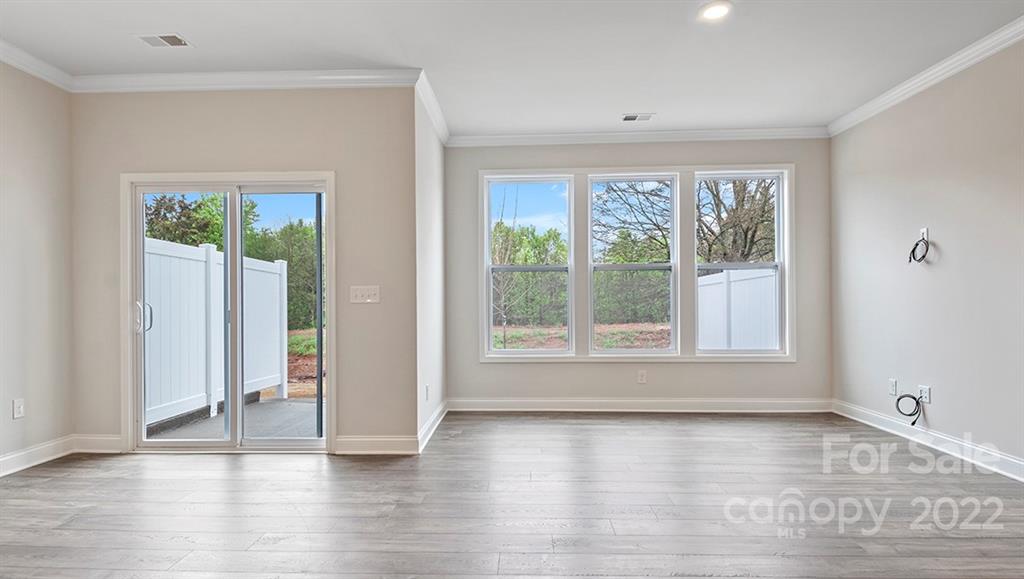 67 Creekview Road Hendersonville, NC 28792 - Photo 11 of 25 an empty room with wooden floor and windows