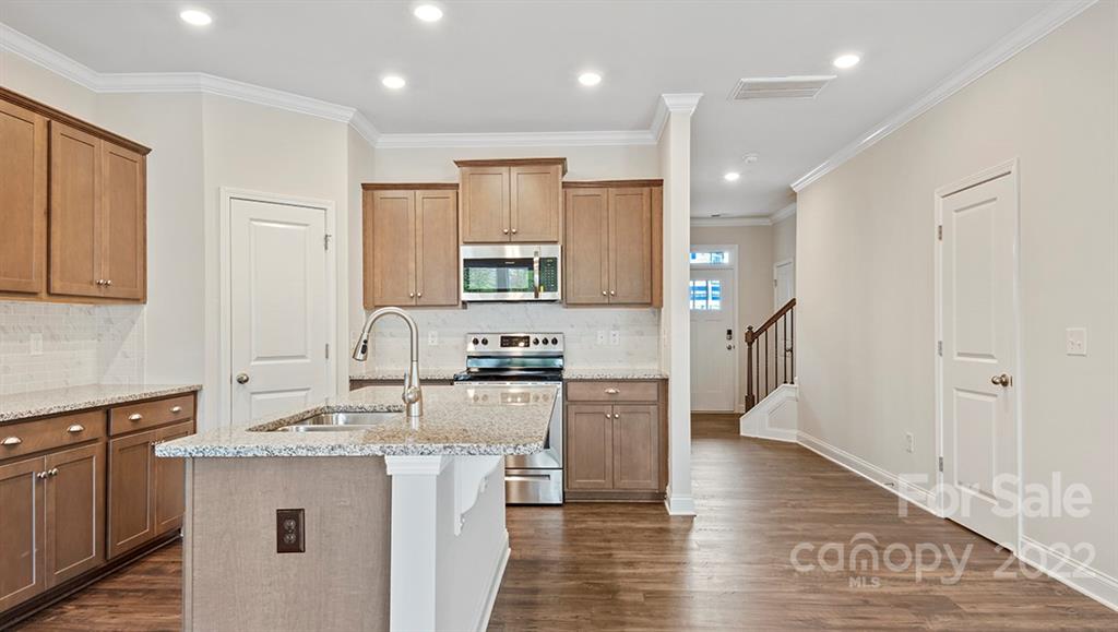 67 Creekview Road Hendersonville, NC 28792 - Photo 7 of 25 a kitchen with stainless steel appliances granite countertop a refrigerator a sink dishwasher a stove and white cabinets with wooden floor