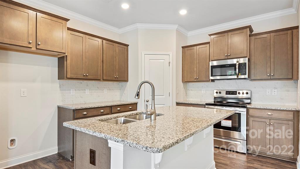 67 Creekview Road Hendersonville, NC 28792 - Photo 8 of 25 a kitchen with granite countertop a stove and a sink