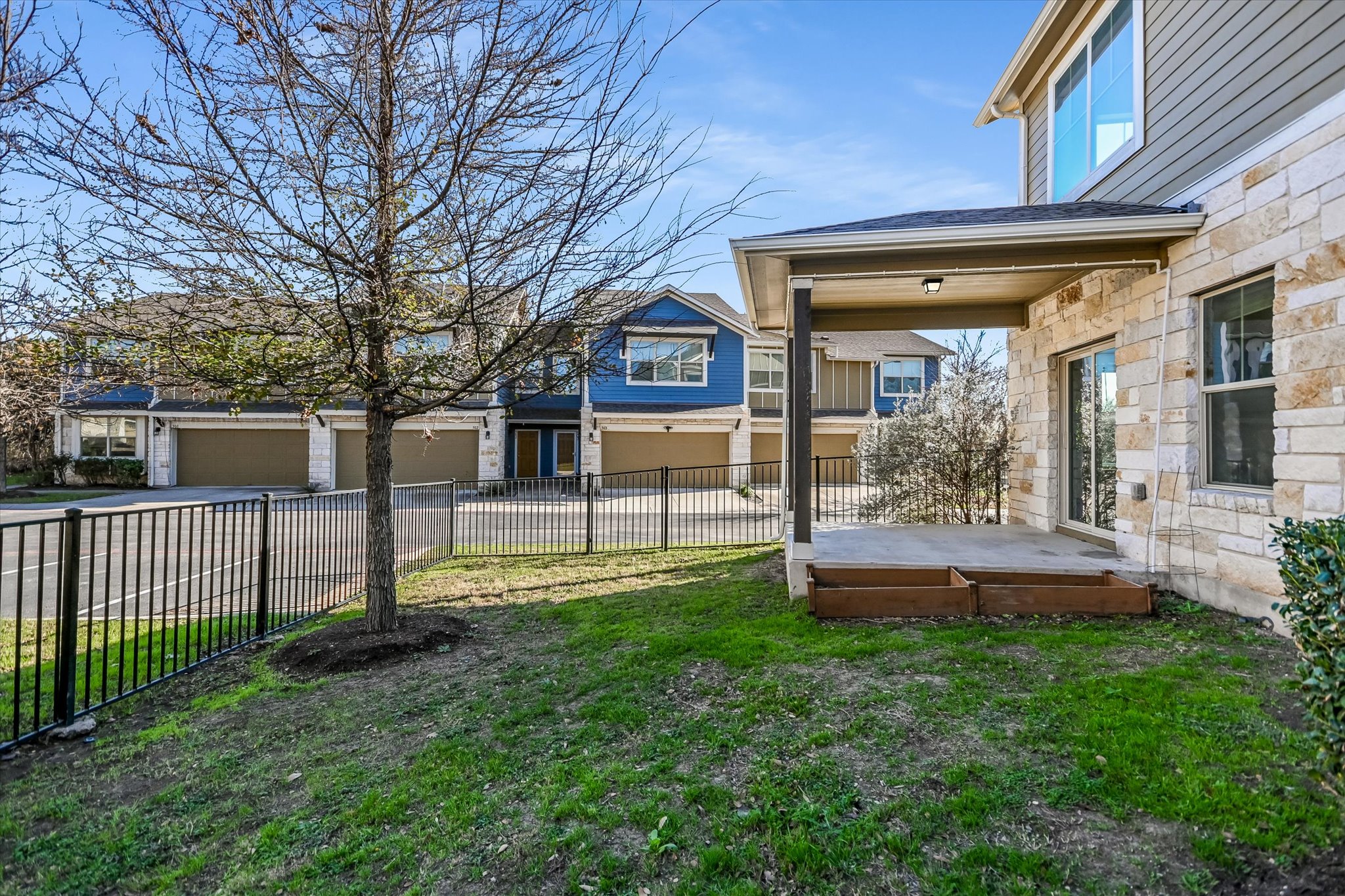 516 East Slaughter Lane, Unit 604 Austin, TX 78744 - Photo 28 of 35 a front view of a house with a yard table and chairs