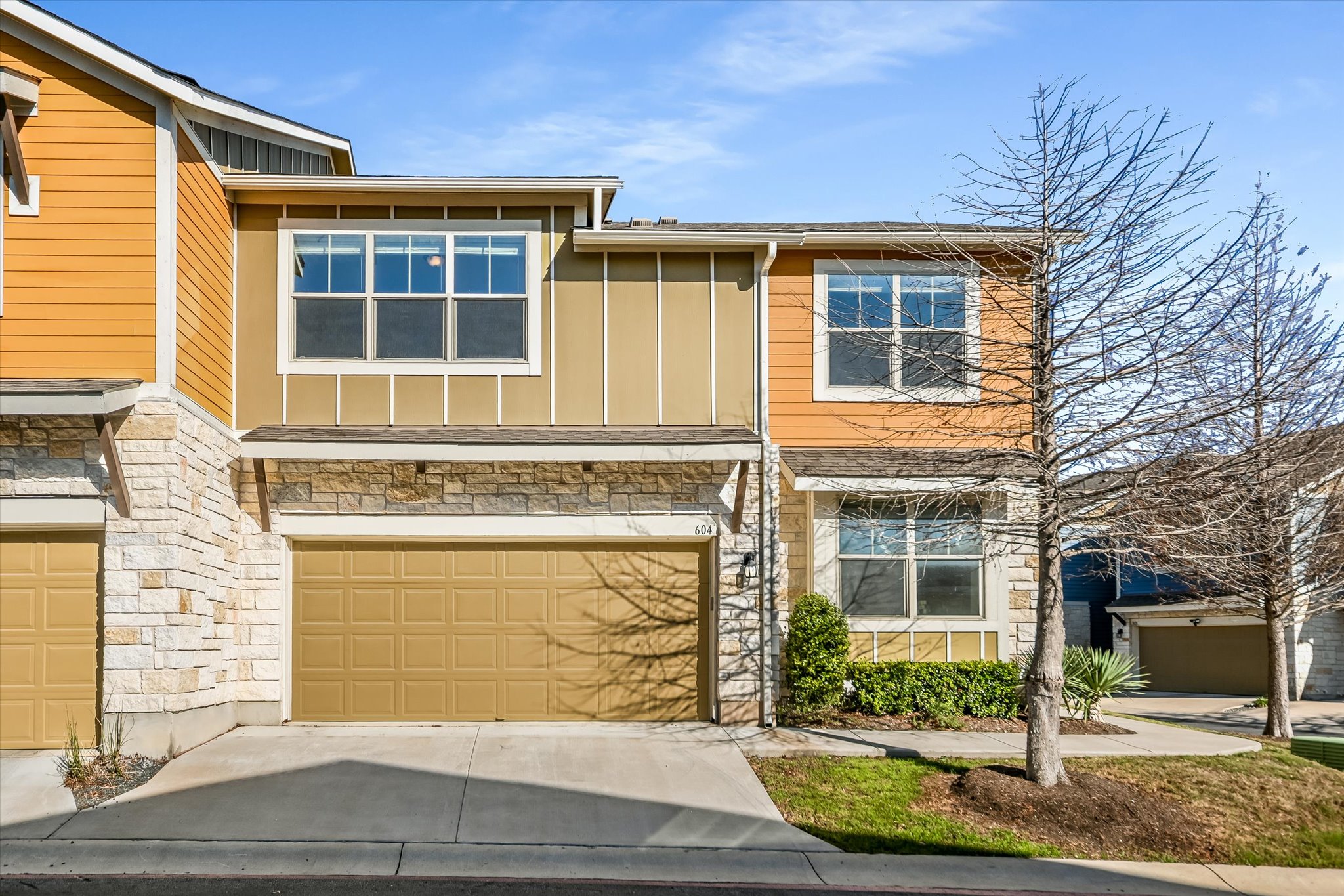 516 East Slaughter Lane, Unit 604 Austin, TX 78744 - Photo 3 of 35 a front view of a house with a yard and garage