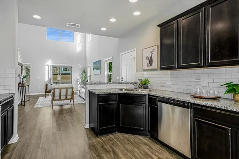 a kitchen with stainless steel appliances granite countertop a stove and a sink