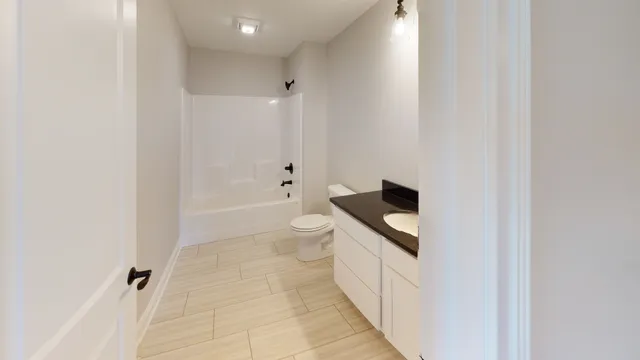 a bathroom with a toilet a sink and bathtub