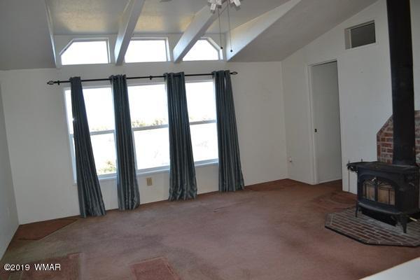 735 2300 North Snowflake, AZ 85937 - Photo 15 of 59 a view of an empty room with a fireplace and a window