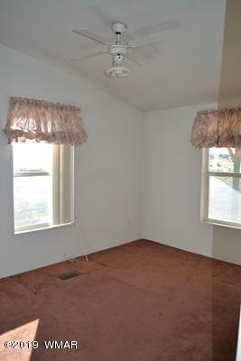 735 2300 North Snowflake, AZ 85937 - Photo 22 of 59 an empty room with a chandelier fan and windows
