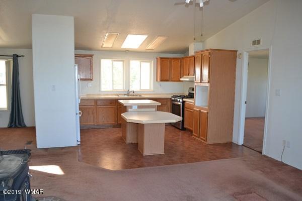 735 2300 North Snowflake, AZ 85937 - Photo 4 of 59 a kitchen with a sink and a refrigerator