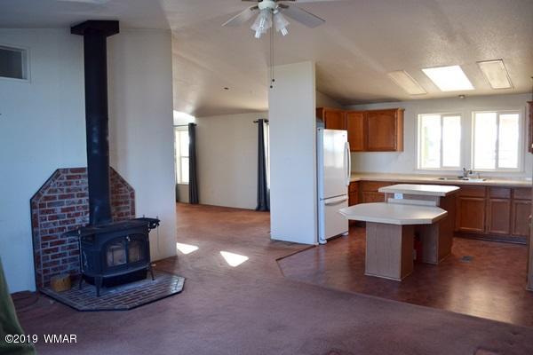 735 2300 North Snowflake, AZ 85937 - Photo 5 of 59 a living room with furniture a table and kitchen chandelier