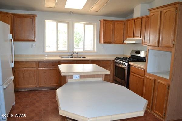 735 2300 North Snowflake, AZ 85937 - Photo 6 of 59 a kitchen with a sink a stove and cabinets