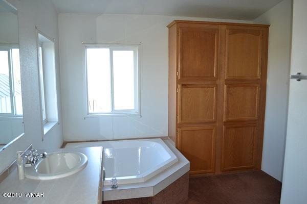 735 2300 North Snowflake, AZ 85937 - Photo 10 of 59 a bath tub sitting in a bathroom next to a sink