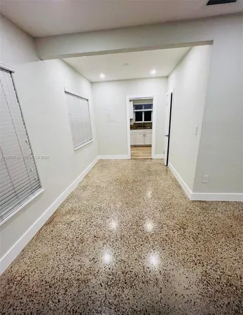 a view of a hallway with a refrigerator