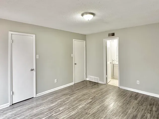 a view of an empty room and wooden floor