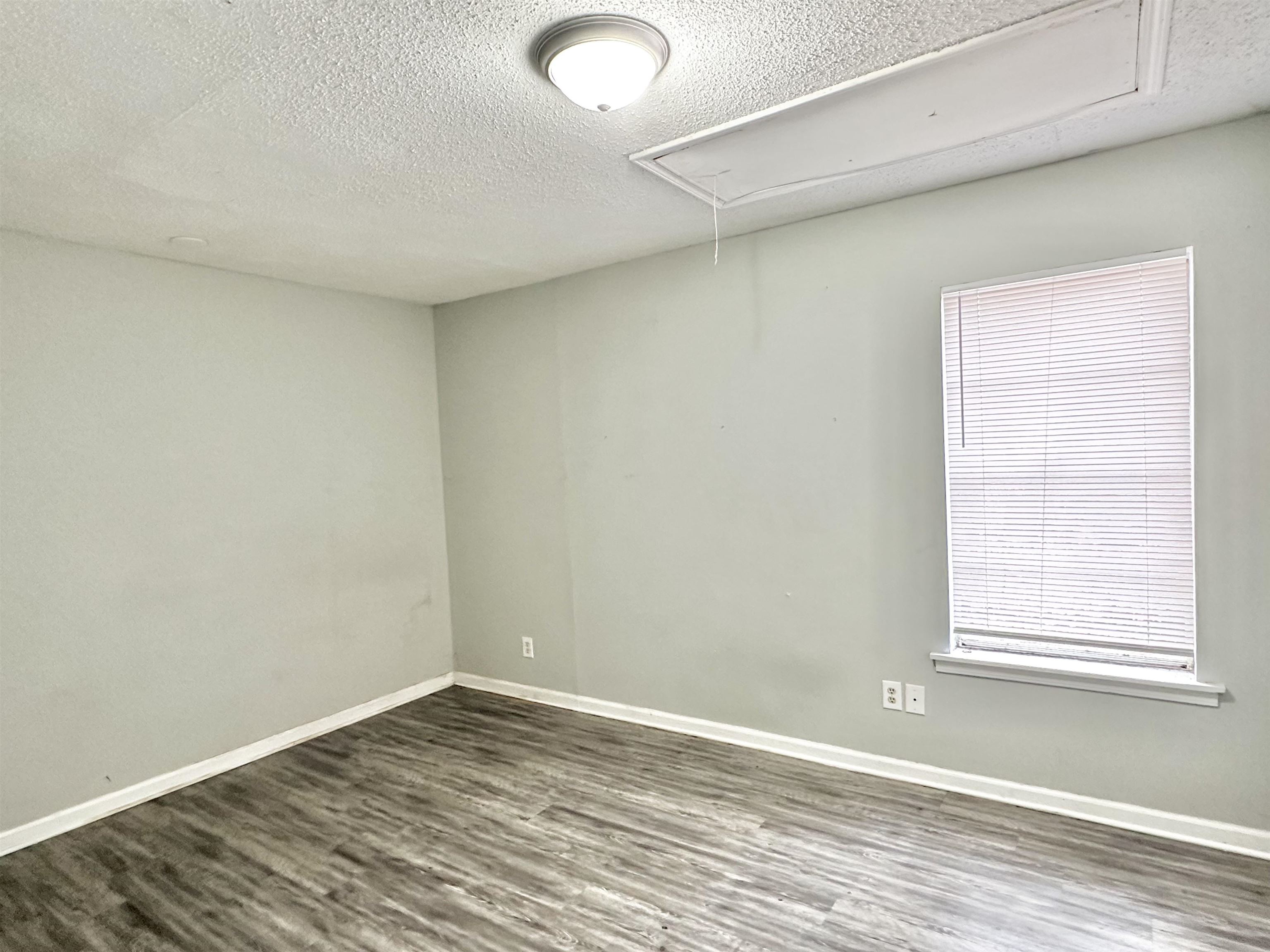 2065 Goldbrier Lane, Unit 2067 Memphis, TN 38134 - Photo 12 of 22 an empty room with wooden floor and windows
