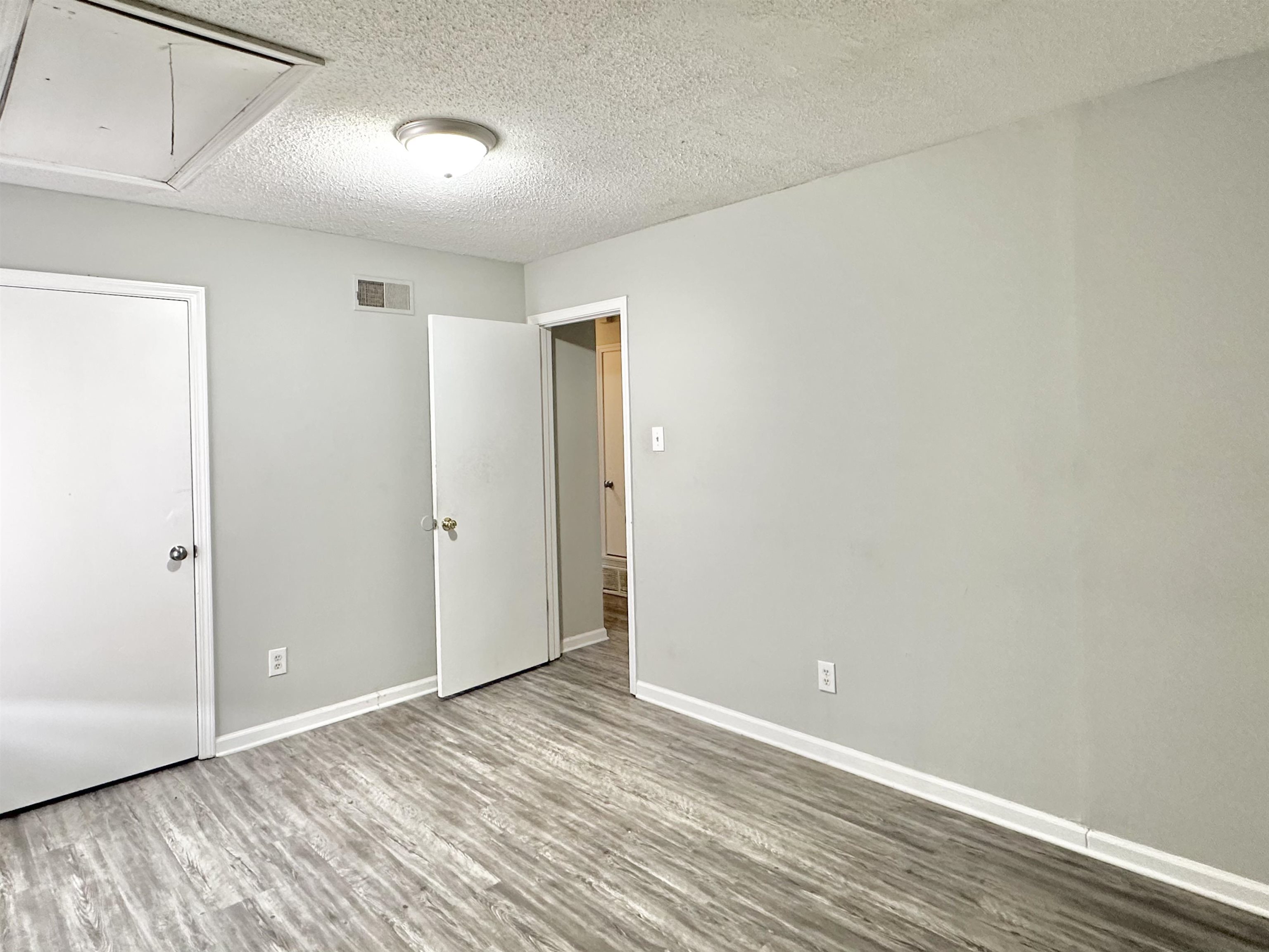 2065 Goldbrier Lane, Unit 2067 Memphis, TN 38134 - Photo 13 of 22 a view of an empty room with wooden floor