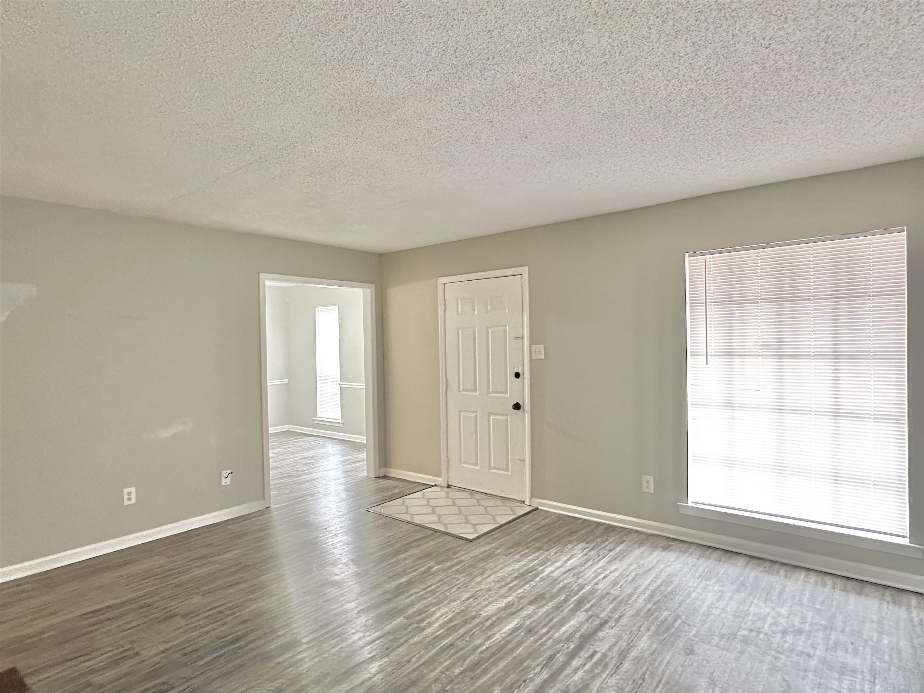 2065 Goldbrier Lane, Unit 2067 Memphis, TN 38134 - Photo 18 of 22 an empty room with wooden floor and windows