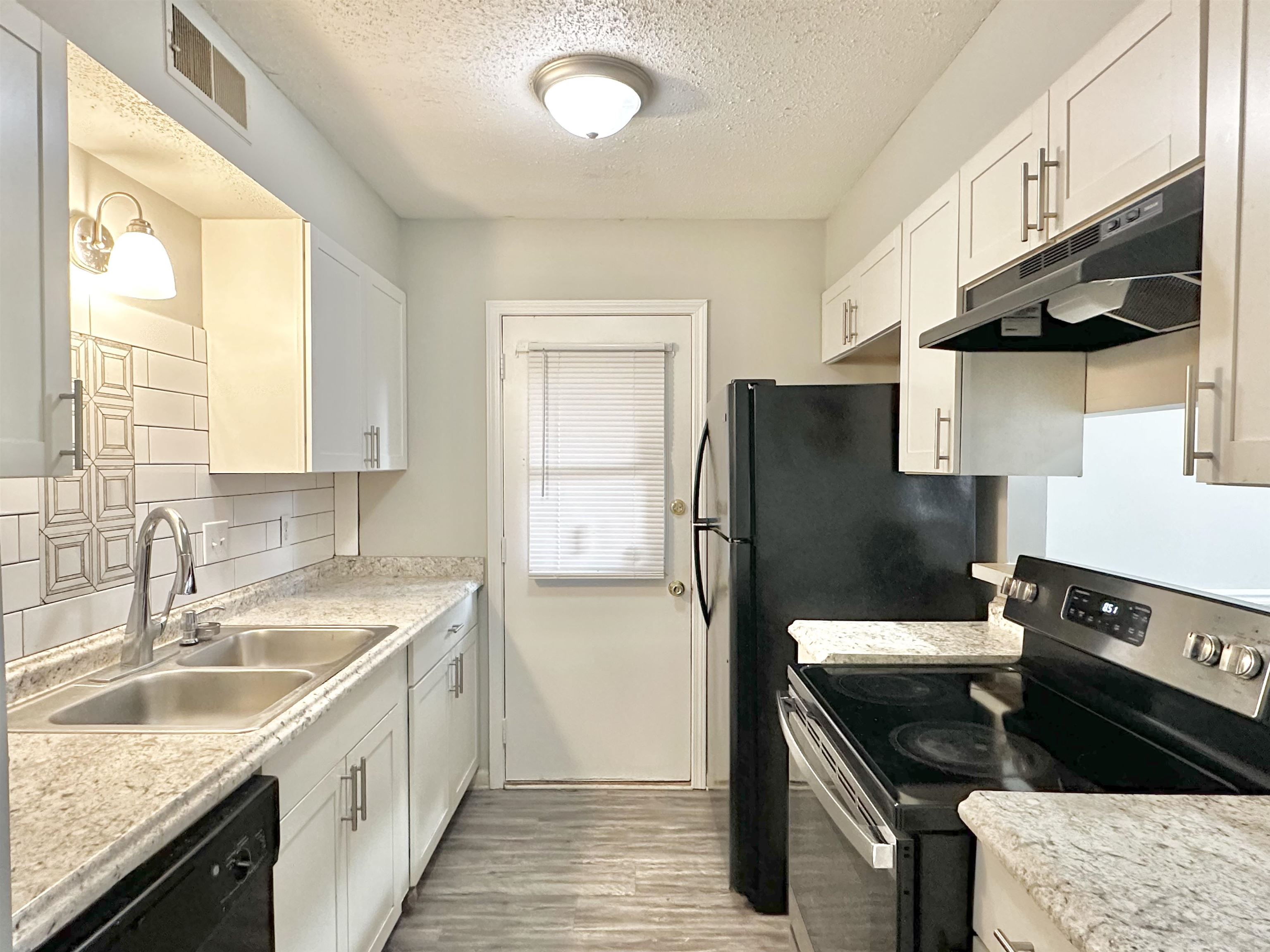 2065 Goldbrier Lane, Unit 2067 Memphis, TN 38134 - Photo 21 of 22 a kitchen with stainless steel appliances granite countertop a sink stove and refrigerator