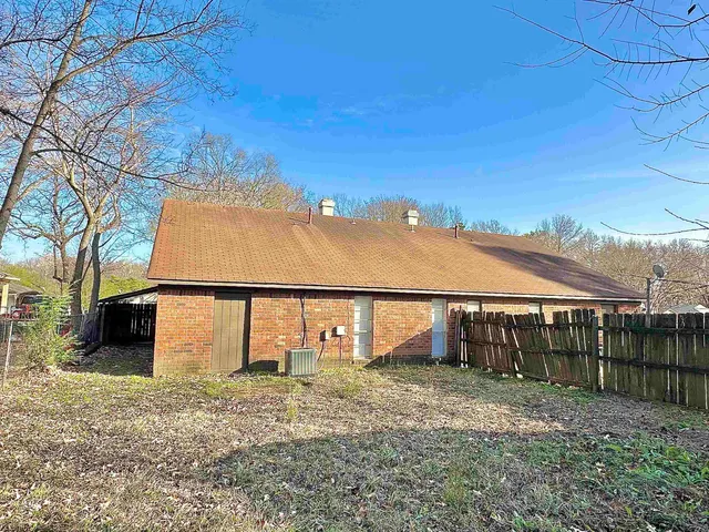 a view of a large house with a big yard and large tree