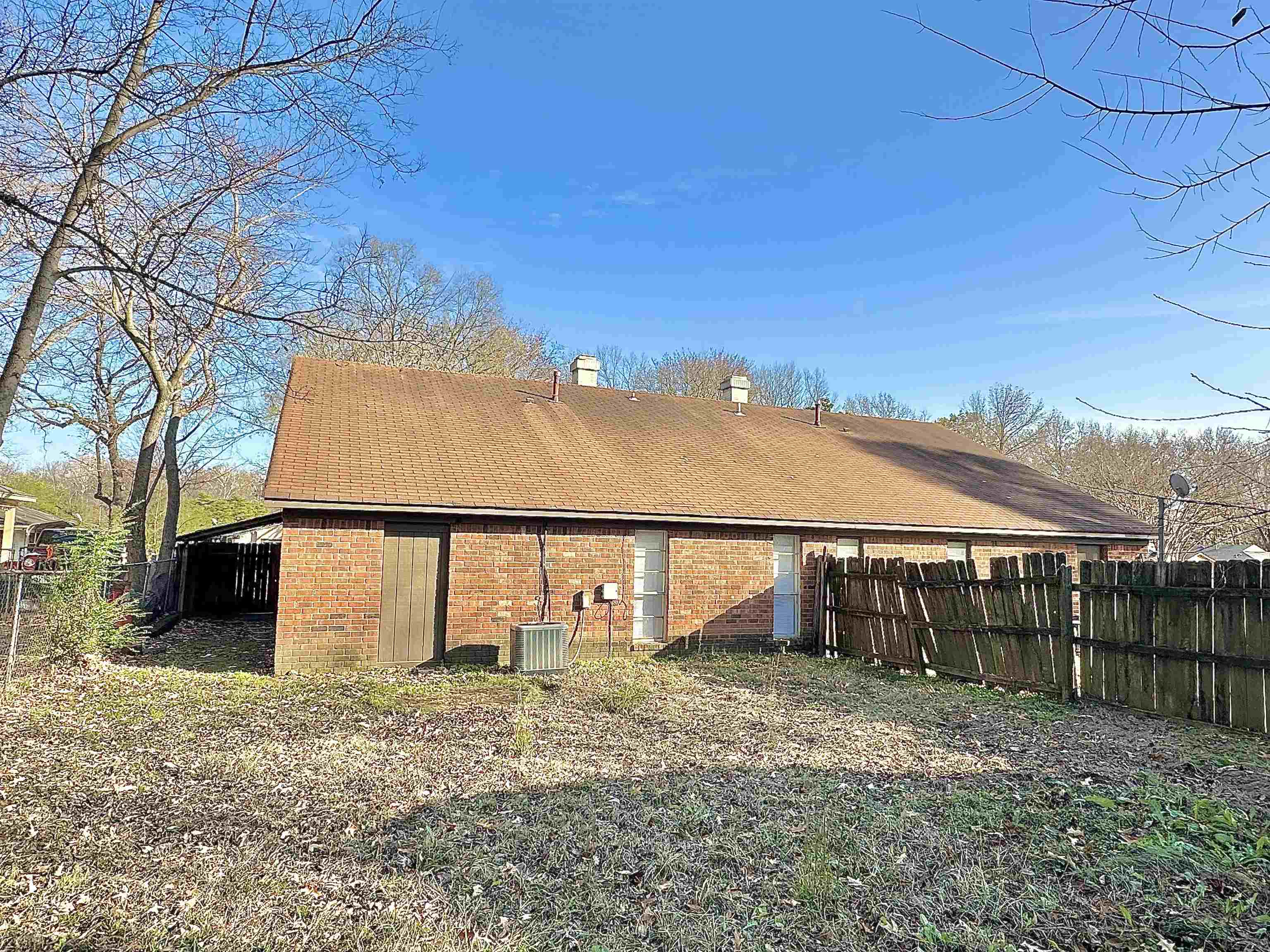 2065 Goldbrier Lane, Unit 2067 Memphis, TN 38134 - Photo 5 of 22 a view of a large house with a big yard and large tree