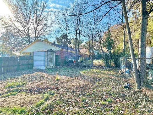 a backyard of a house with lots of green space