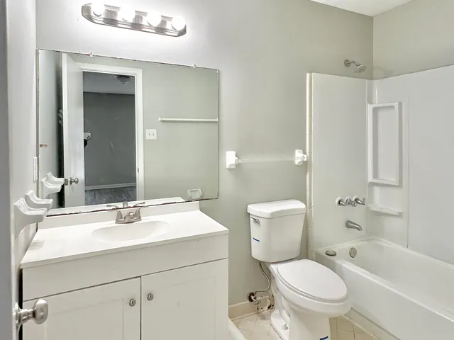 a bathroom with a sink toilet tub and shower