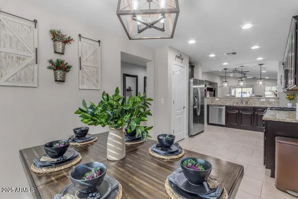a kitchen with stainless steel appliances kitchen island table and chairs