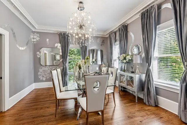 a view of a dining room with furniture a chandelier and wooden floor