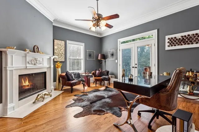 a dining room with furniture a fireplace and wooden floor
