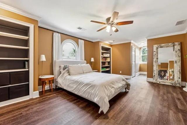 a bedroom with a large bed and a chandelier