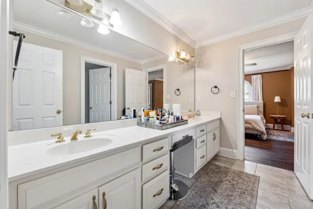 a spacious bathroom with a double vanity sink mirror and shower