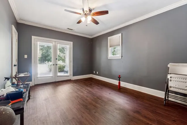 a view of room with hardwood floor and ceiling fan