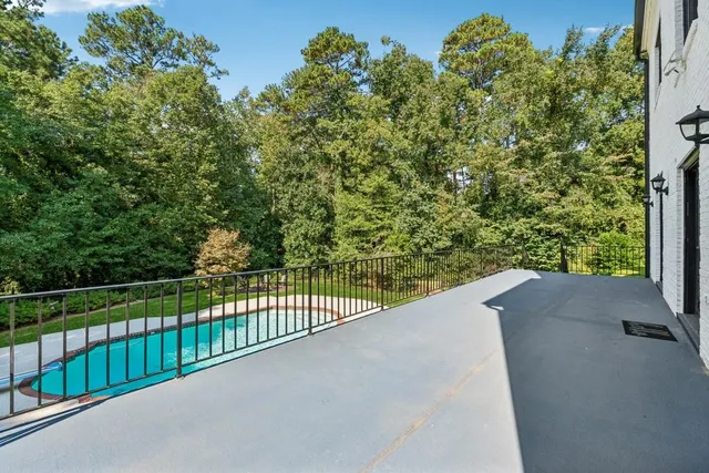 a view of a fence and trees in the background